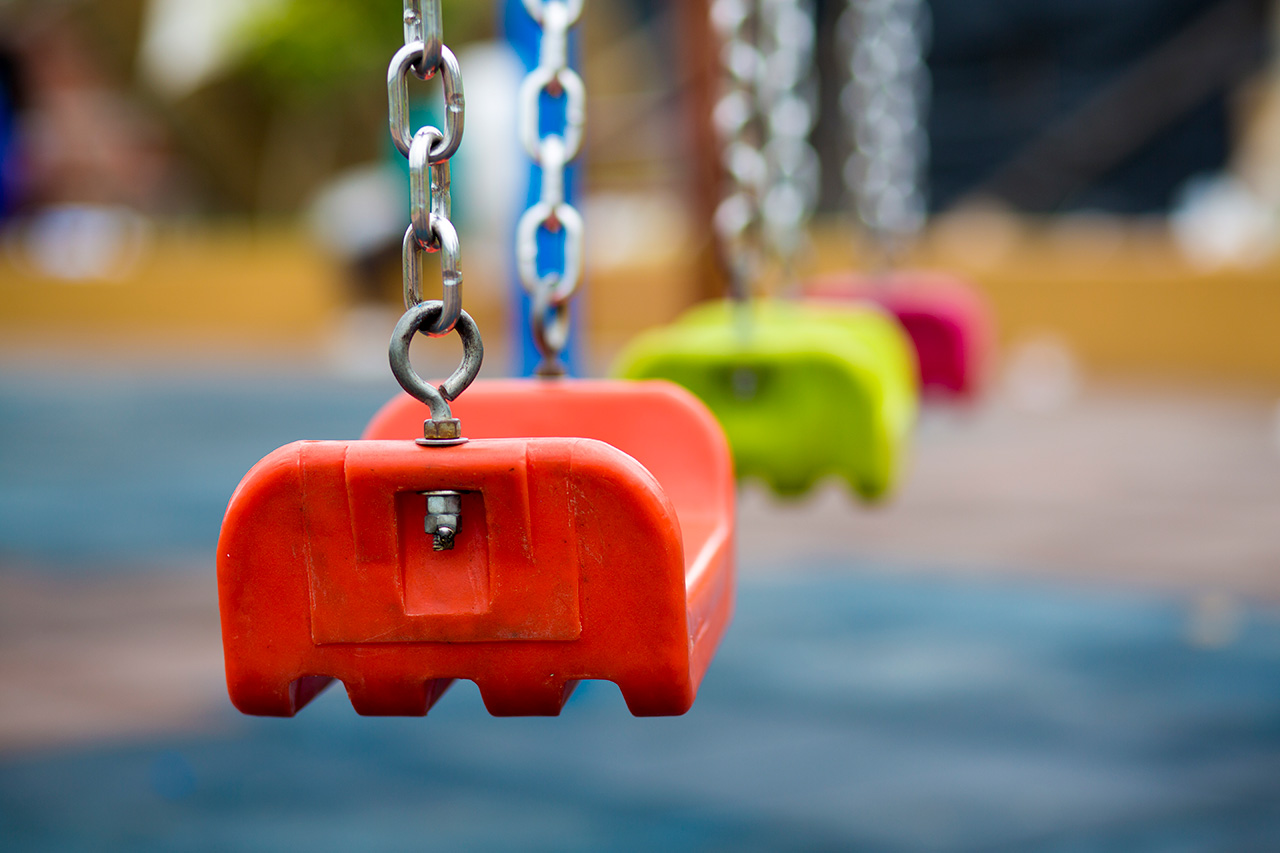 Close-up-of-empty-swing-in-a-playground-